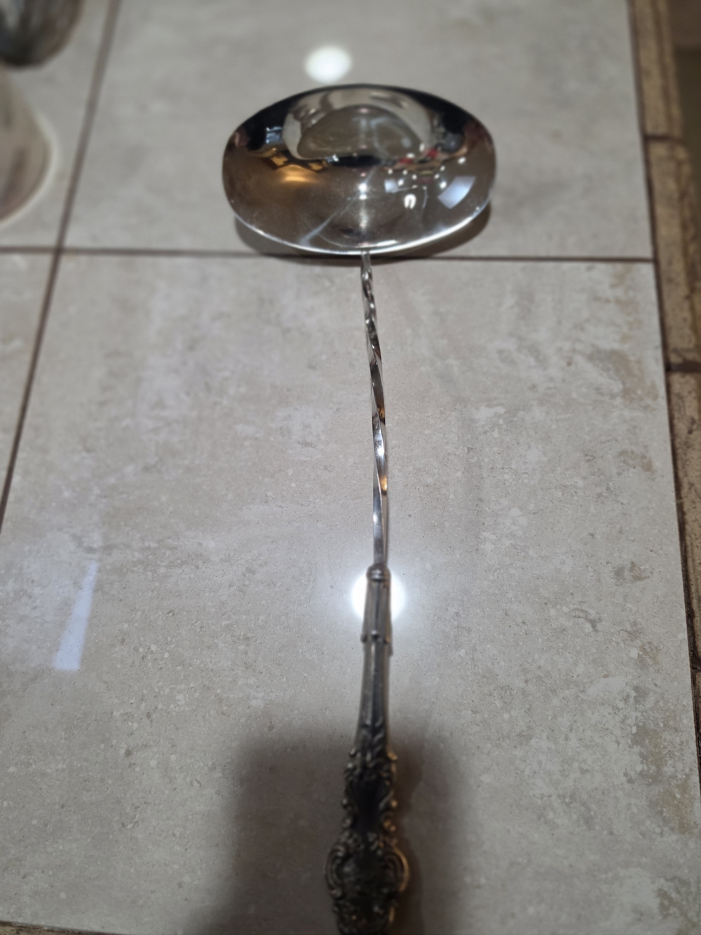 Polished Silver Serving Ladle with Ornate Handle